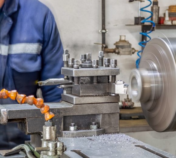 blue-collar-machine-operator-working-with-lathe-machine-in-a-factory_t20_LzQxaP.jpg